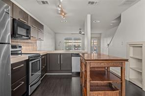 1101 Grove Boulevard, Unit 206 Austin, TX 78741 - Photo 22 of 23 a kitchen with stainless steel appliances granite countertop a stove and a sink