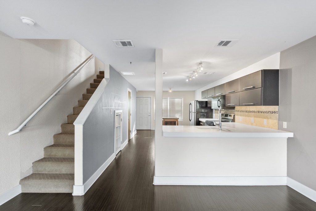 1101 Grove Boulevard, Unit 206 Austin, TX 78741 - Photo 9 of 23 a view of kitchen with cabinets and wooden floor