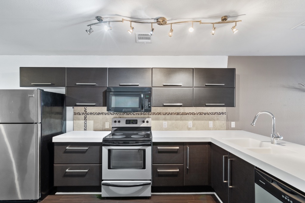 1101 Grove Boulevard, Unit 206 Austin, TX 78741 - Photo 10 of 23 a kitchen with a sink and a stove