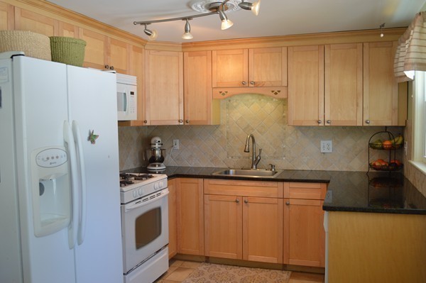 4 Hadley Road Framingham, MA 01701 - Photo 5 of 14 a kitchen with stainless steel appliances granite countertop a refrigerator sink and cabinets