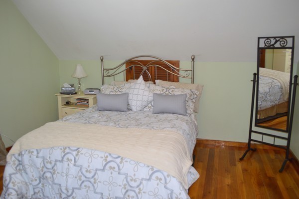 4 Hadley Road Framingham, MA 01701 - Photo 9 of 14 a bedroom with a bed and wooden floor