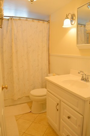 4 Hadley Road Framingham, MA 01701 - Photo 10 of 14 a bathroom with a toilet a sink and shower