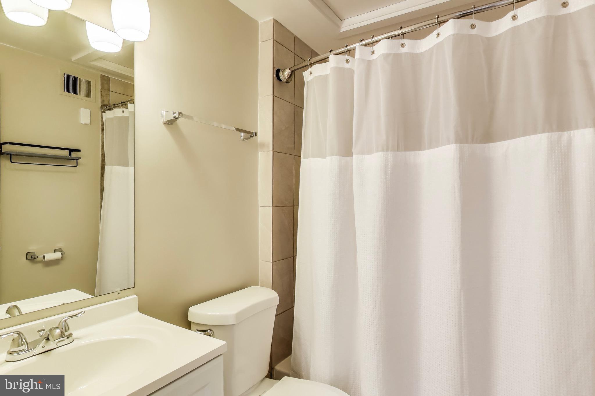 1625 S Street Northwest, Unit 1 Washington, DC 20009 - Photo 9 of 13 a bathroom with a sink toilet and shower