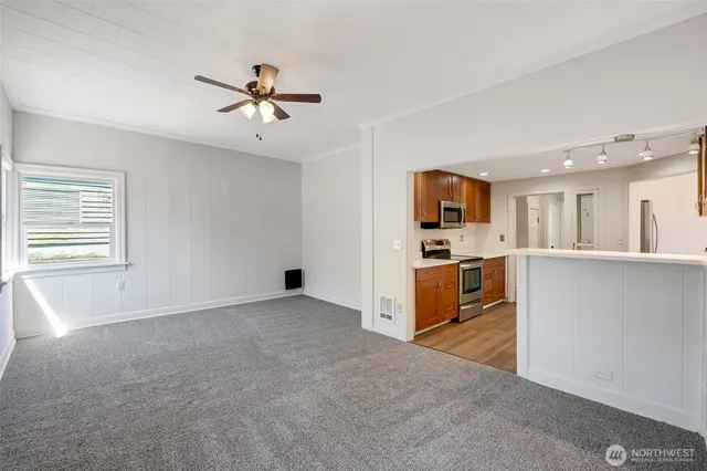 a view of a kitchen with microwave and a sink