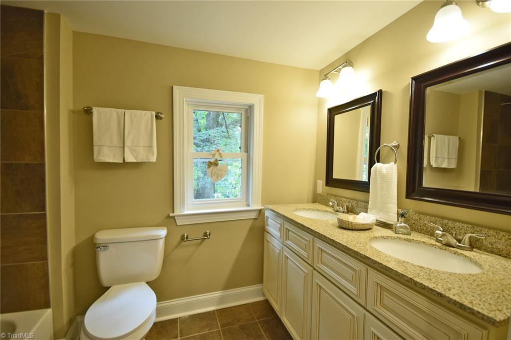 7830 Broad Street Rural Hall, NC 27045 - Photo 13 of 25 A totally modern mater bath with dual vanities and tile shower and flooring.