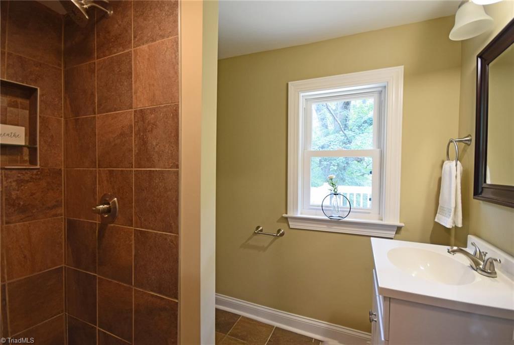 7830 Broad Street Rural Hall, NC 27045 - Photo 17 of 25 The second full bath features a step in tile shower.
