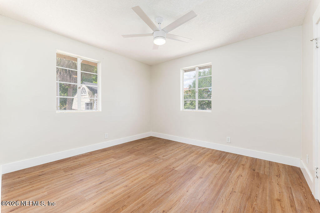 2247 Riverside Avenue, Unit 6 Jacksonville, FL 32204 - Photo 11 of 16 an empty room with wooden floor and windows