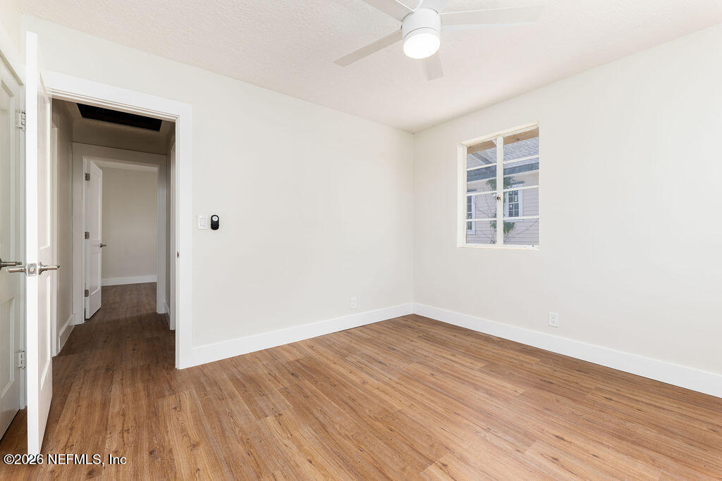 2247 Riverside Avenue, Unit 6 Jacksonville, FL 32204 - Photo 12 of 16 a view of an empty room with wooden floor and a window