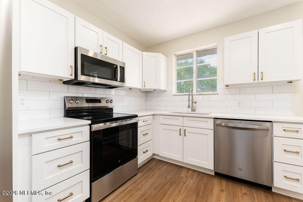 2247 Riverside Avenue, Unit 6 Jacksonville, FL 32204 - Photo 5 of 16 a kitchen with stainless steel appliances white cabinets a sink and a stove