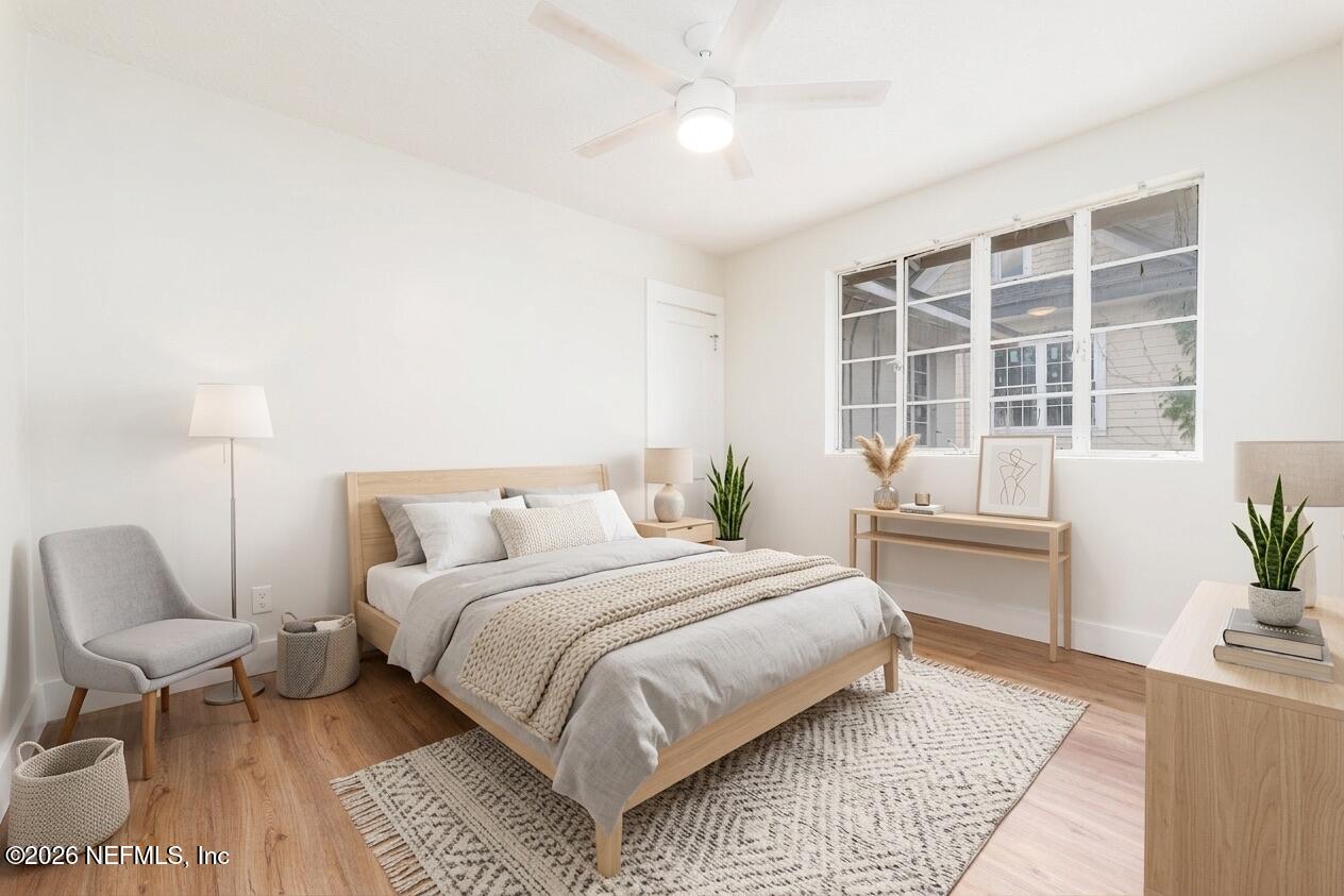 2247 Riverside Avenue, Unit 6 Jacksonville, FL 32204 - Photo 6 of 16 a bedroom with a large bed and a couch