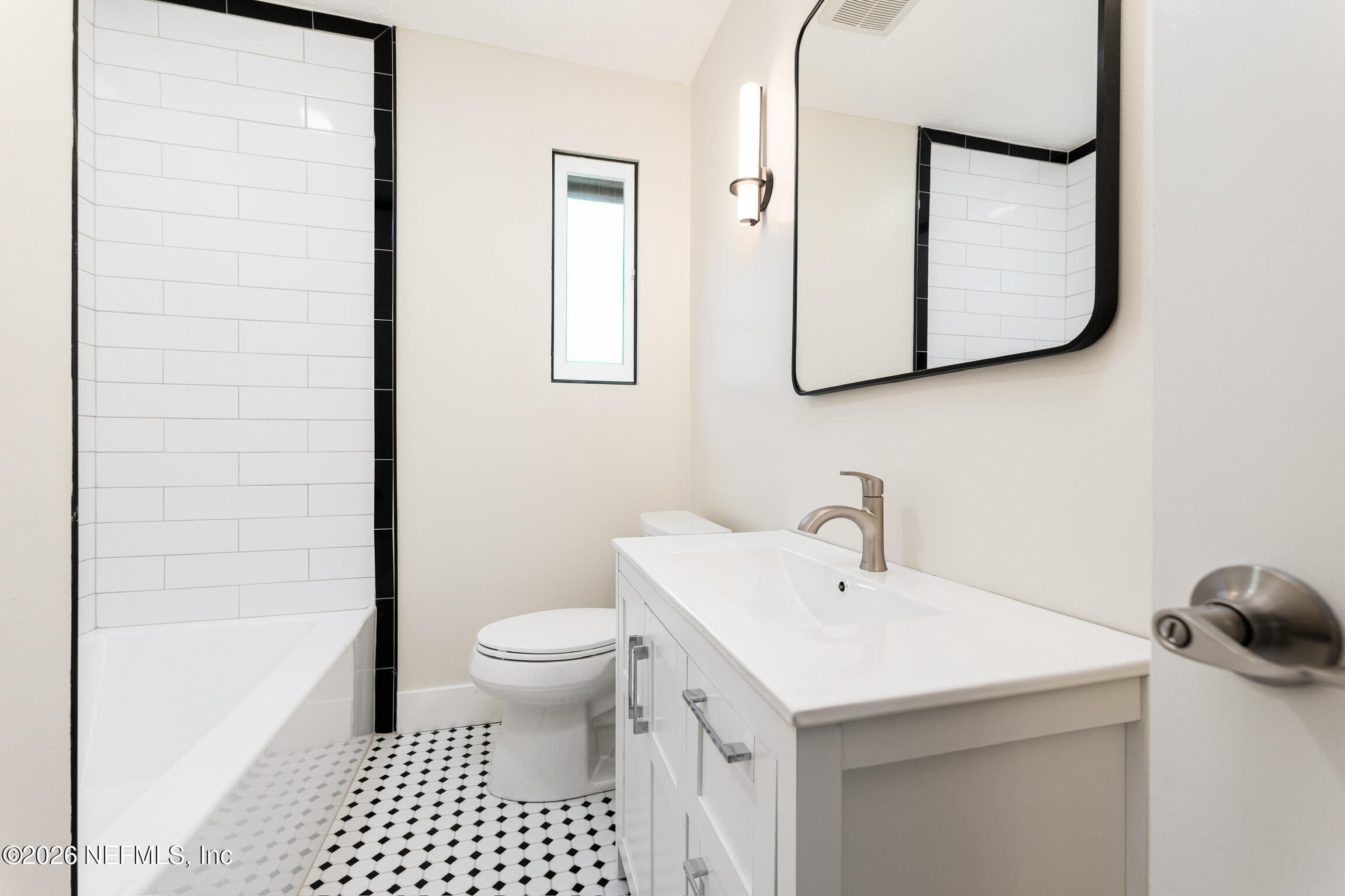 2247 Riverside Avenue, Unit 6 Jacksonville, FL 32204 - Photo 9 of 16 a bathroom with a sink and a mirror