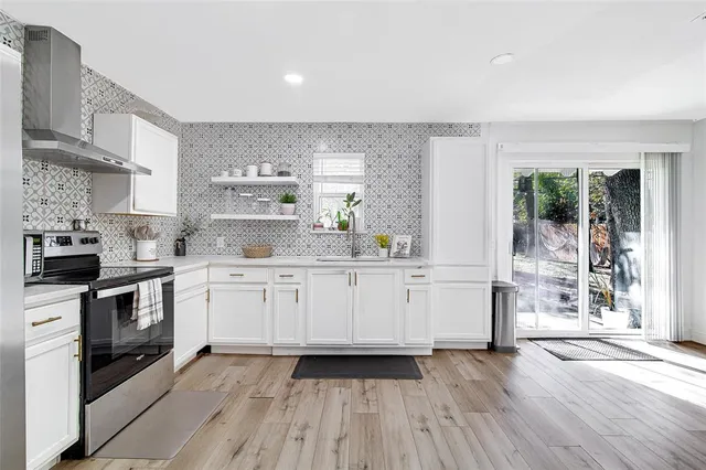 a kitchen with wooden floors and white appliances