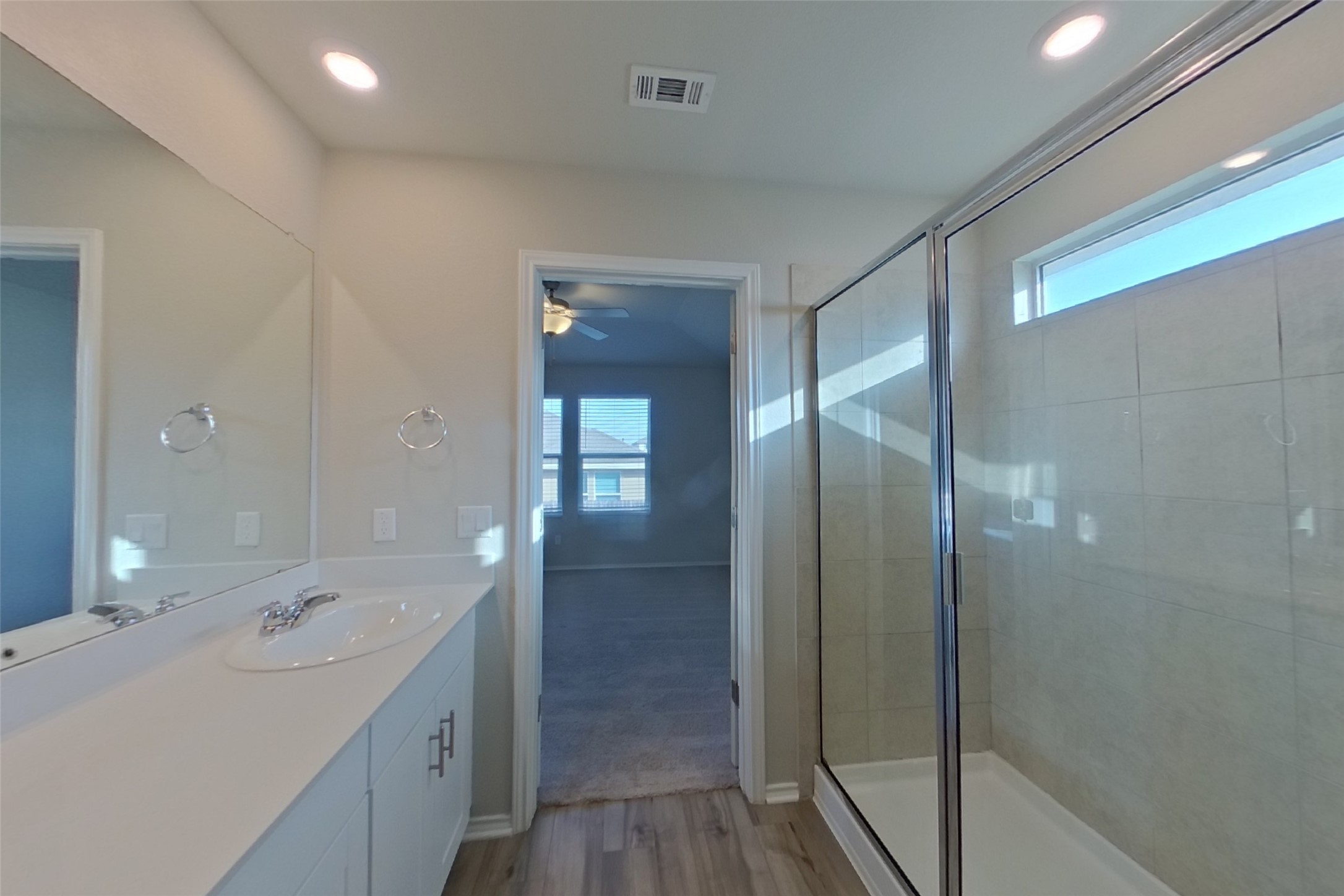 3525 Catlett Crk Road Georgetown, TX 78626 - Photo 8 of 16 Clean lines and modern tile finishes define this primary bathroom complete with a walk-in shower.