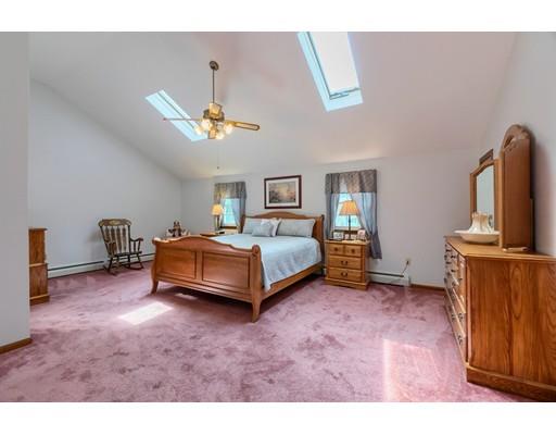 21 Bemis Road Pepperell, MA 01463 - Photo 20 of 27 a spacious bedroom with a bed a dresser and potted plants