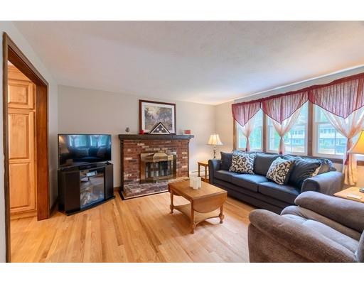 21 Bemis Road Pepperell, MA 01463 - Photo 4 of 27 a living room with furniture a flat screen tv and a fireplace