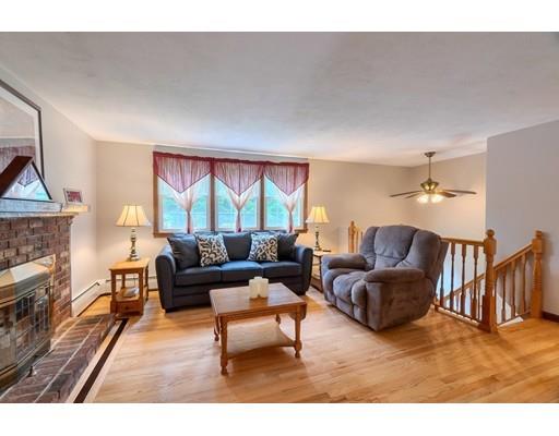 21 Bemis Road Pepperell, MA 01463 - Photo 5 of 27 a living room with furniture a fireplace and a large window