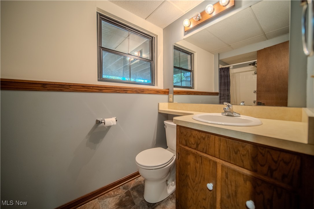 3459 Laubert Road Atwater, OH 44201 - Photo 27 of 39 Full bath with vanity, a shower with curtain, and stone finish flooring