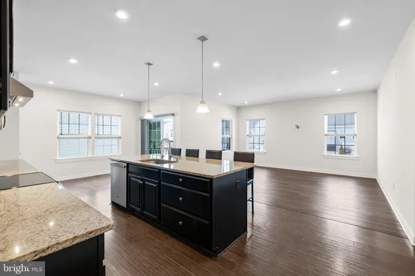 a kitchen with stainless steel appliances granite countertop a stove and a sink