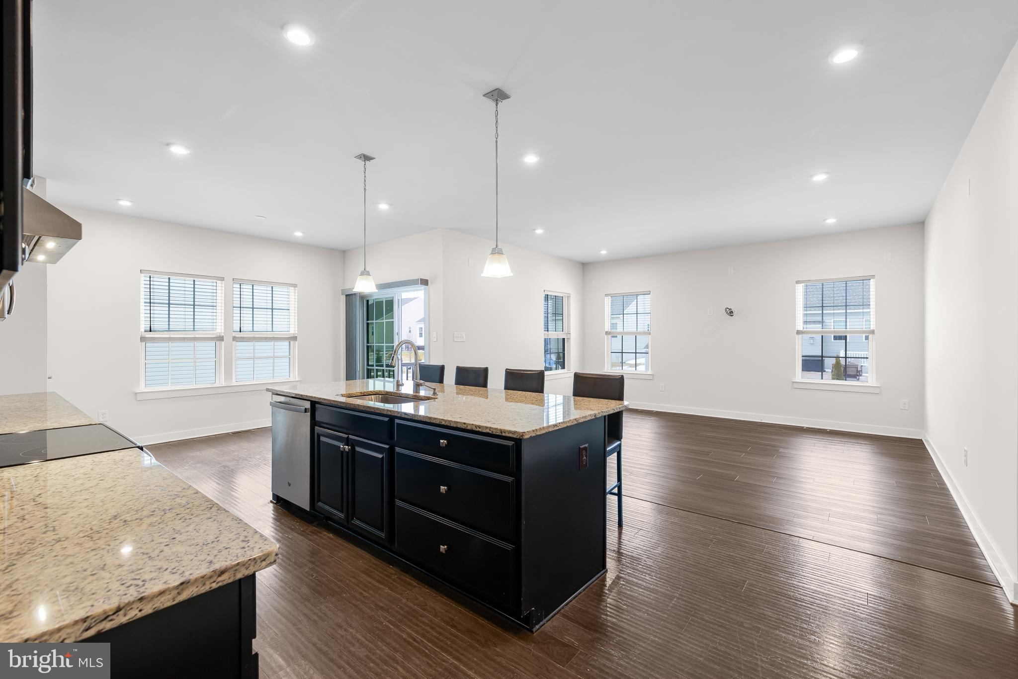 929 Robinson Road Townsend, DE 19734 - Photo 11 of 57 a kitchen with stainless steel appliances granite countertop a sink a stove and a wooden floor