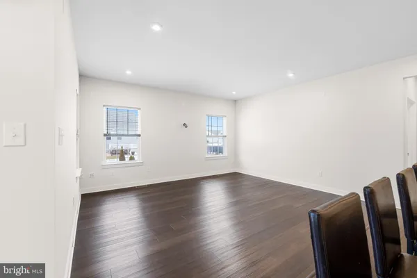 a view of a kitchen with dining table and chairs