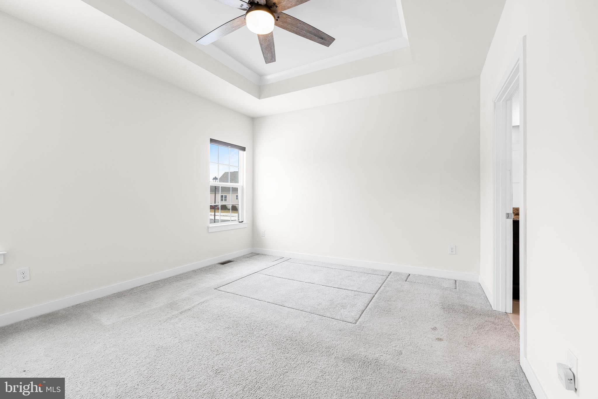 929 Robinson Road Townsend, DE 19734 - Photo 29 of 57 an empty room with a ceiling fan and a window