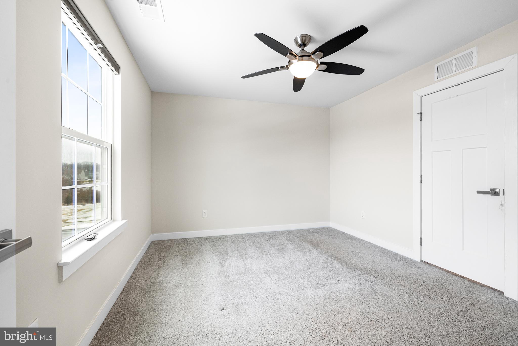 929 Robinson Road Townsend, DE 19734 - Photo 39 of 57 wooden floor in an empty room with a window