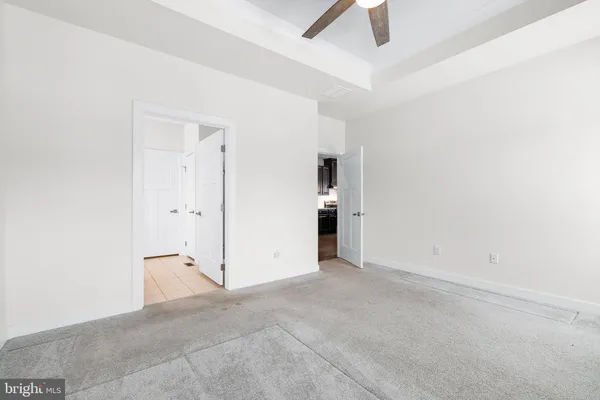 a bathroom with a granite countertop sink a toilet and bathtub