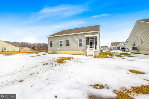 an aerial view of a swimming pool with outdoor seating
