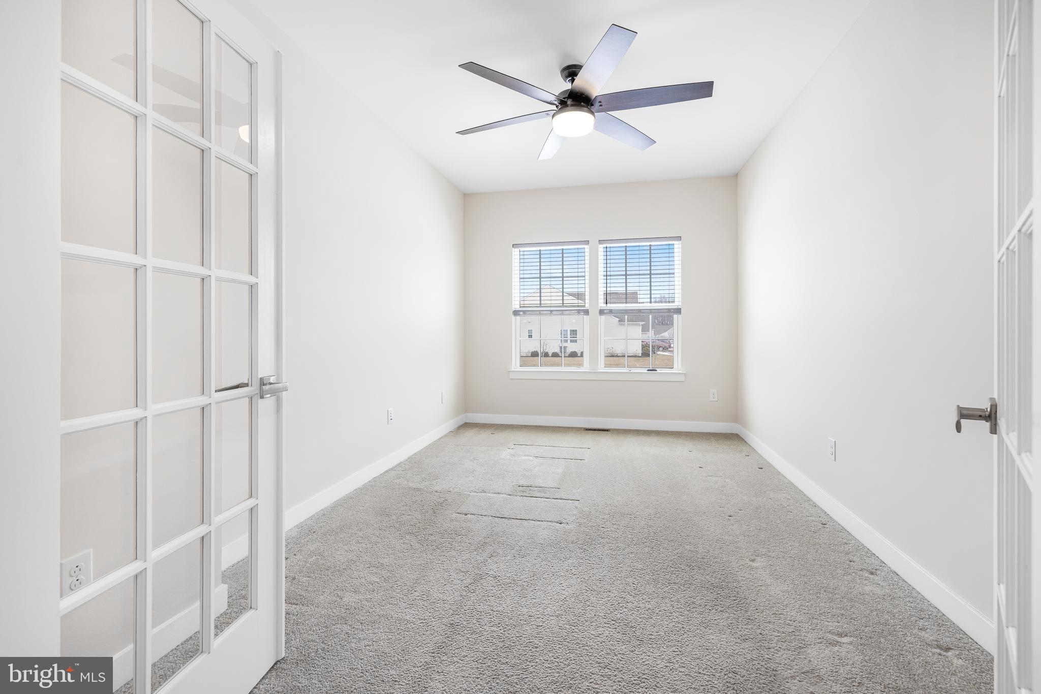929 Robinson Road Townsend, DE 19734 - Photo 7 of 57 an empty room with windows and fan