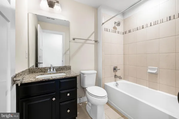 a kitchen with stainless steel appliances granite countertop a sink a stove and a wooden floor