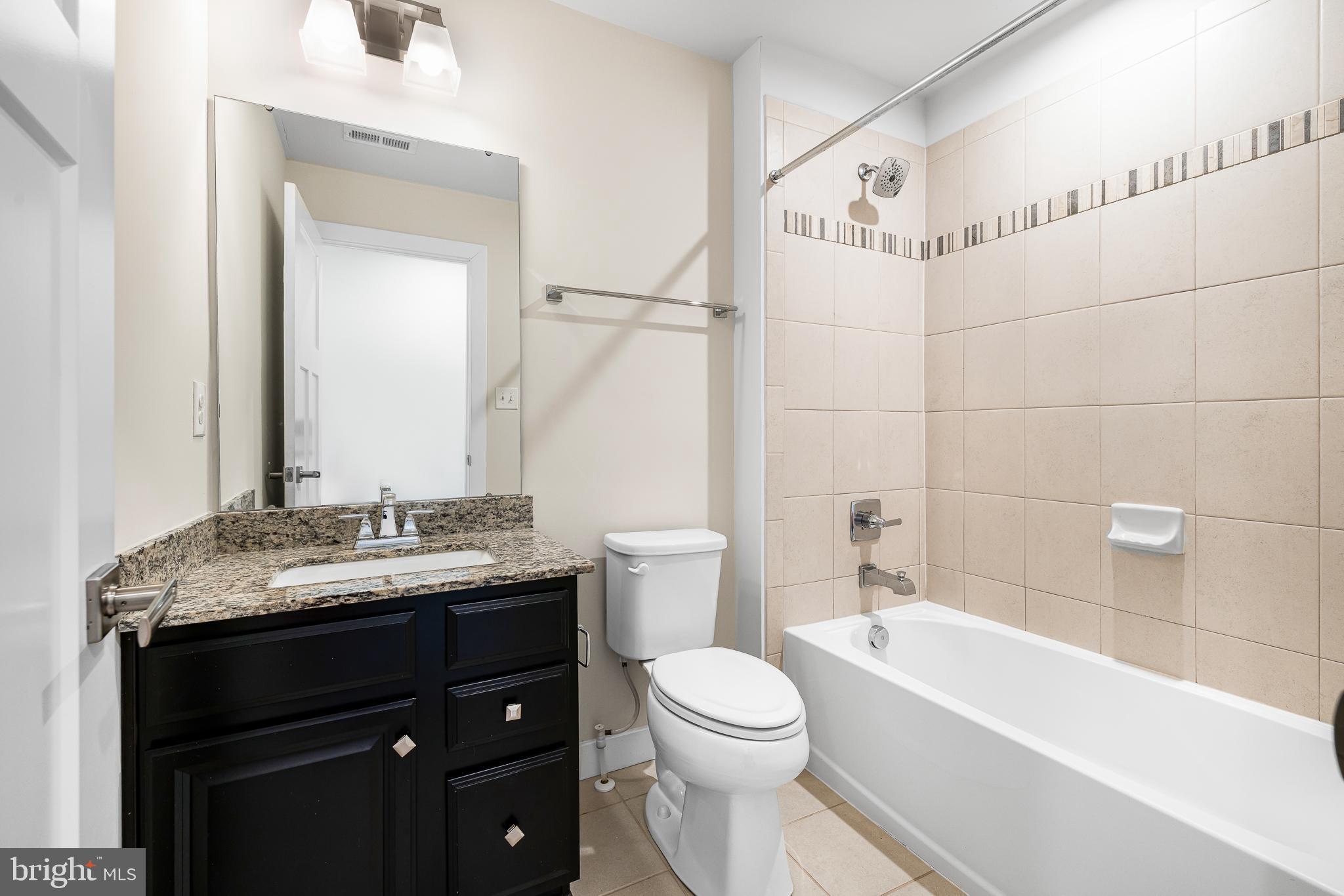 929 Robinson Road Townsend, DE 19734 - Photo 10 of 57 a bathroom with a granite countertop sink a toilet and bathtub