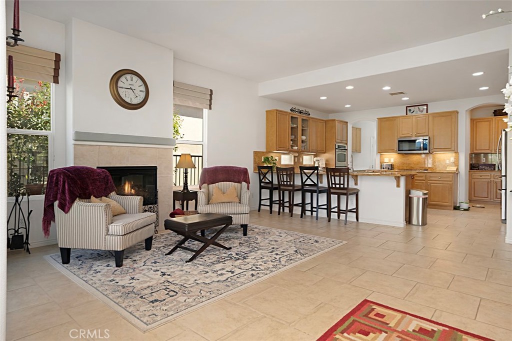 23858 Kaleb Drive Corona, CA 92883 - Photo 18 of 45 a living room with furniture a clock and a fireplace