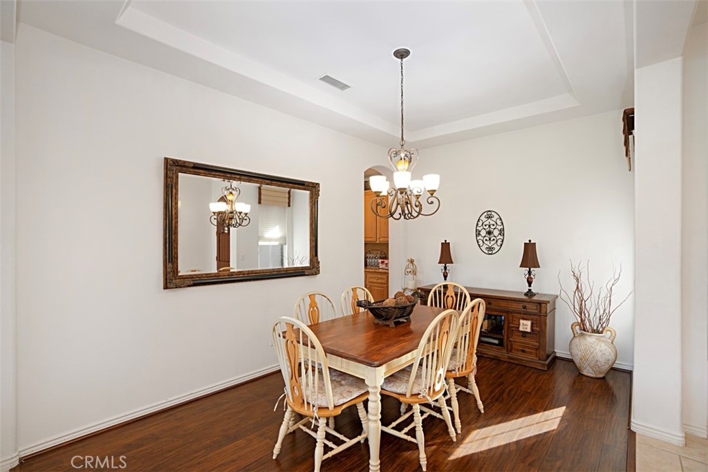 23858 Kaleb Drive Corona, CA 92883 - Photo 21 of 45 a view of a dining room with furniture wooden floor and a chandelier