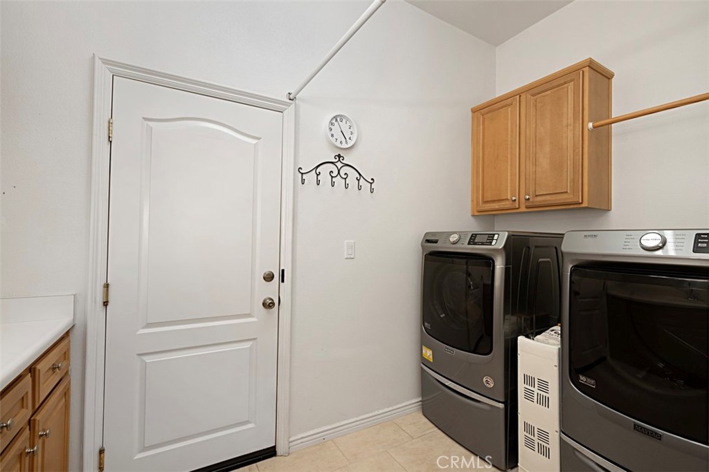 23858 Kaleb Drive Corona, CA 92883 - Photo 22 of 45 a kitchen with a refrigerator and cabinets