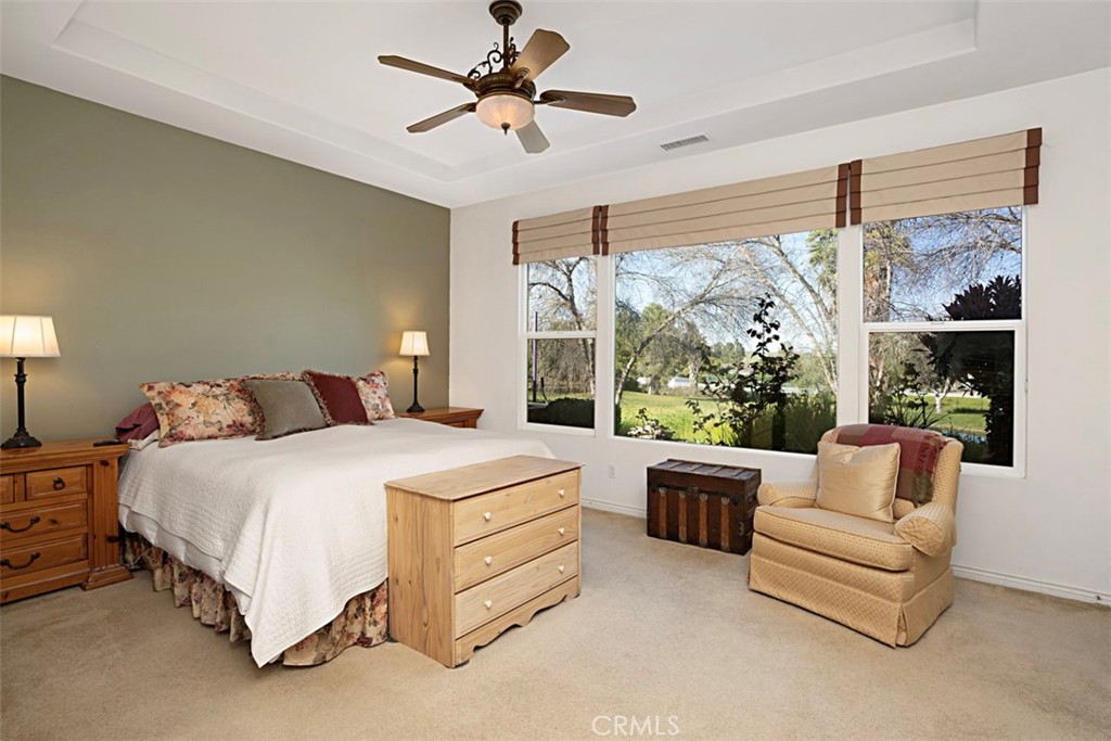 23858 Kaleb Drive Corona, CA 92883 - Photo 25 of 45 a bedroom with a bed couch and large window