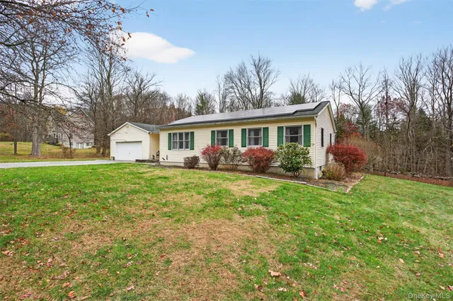a view of house with outdoor space and garden