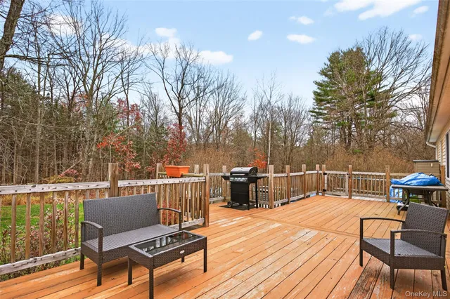 a view of a roof deck with wooden floor and outdoor seating