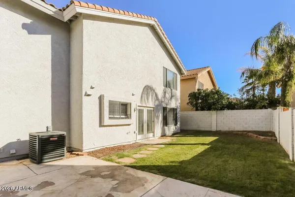 a view of a house with backyard and sitting area