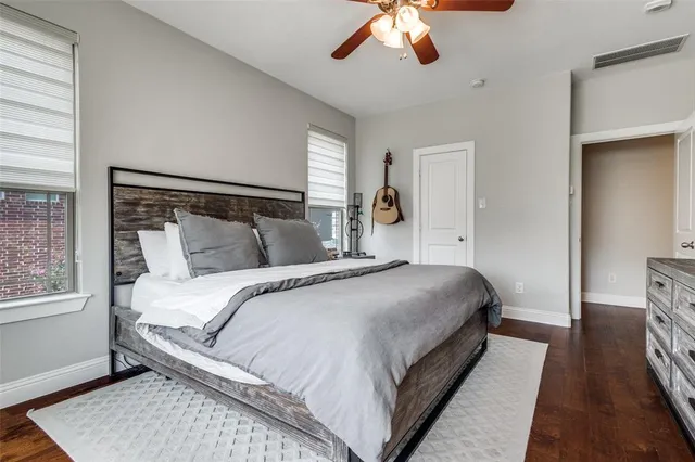 a bedroom with a large bed and a chandelier