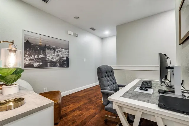 a view of a workspace with furniture and window