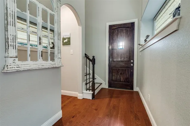 a view of an entryway with wooden floor and stairs