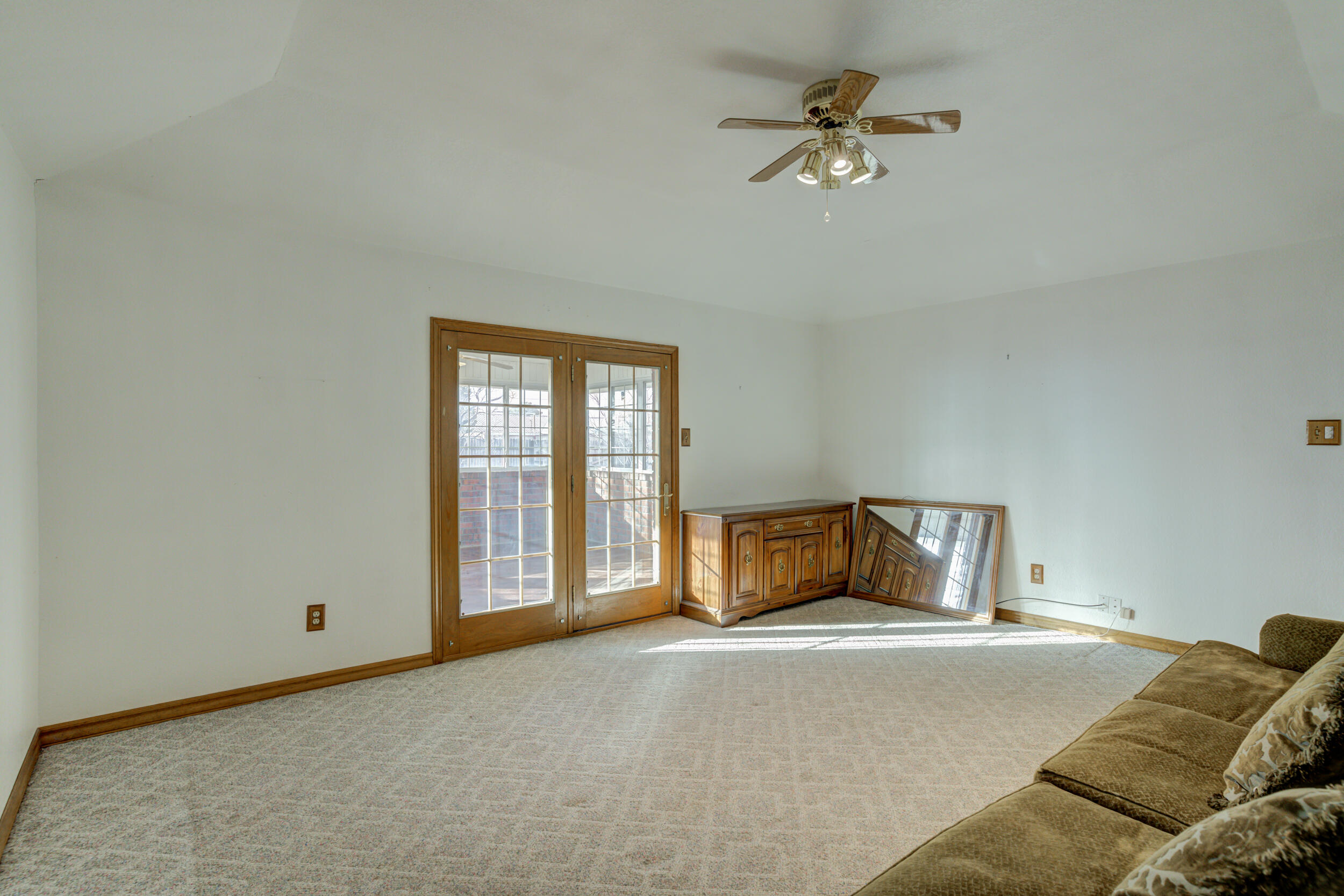 801 19th Street Seagraves, TX 79359 - Photo 12 of 24 a bedroom with a bed and a ceiling fan