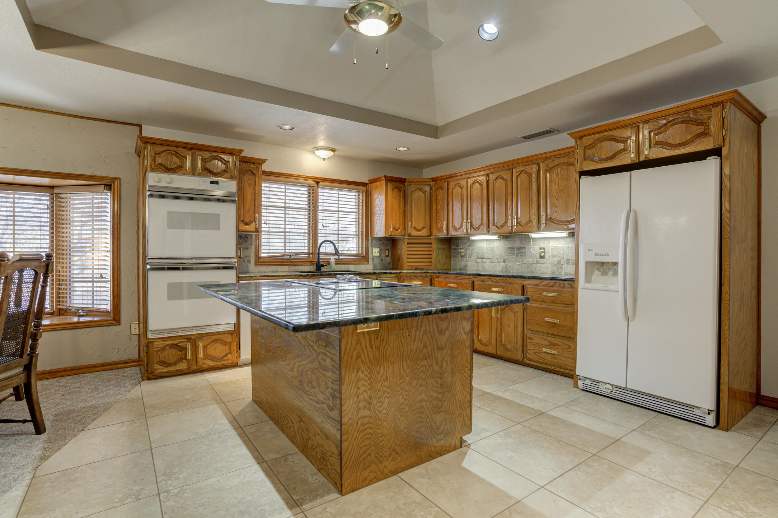 801 19th Street Seagraves, TX 79359 - Photo 14 of 24 a kitchen with stainless steel appliances granite countertop a refrigerator and a stove top oven