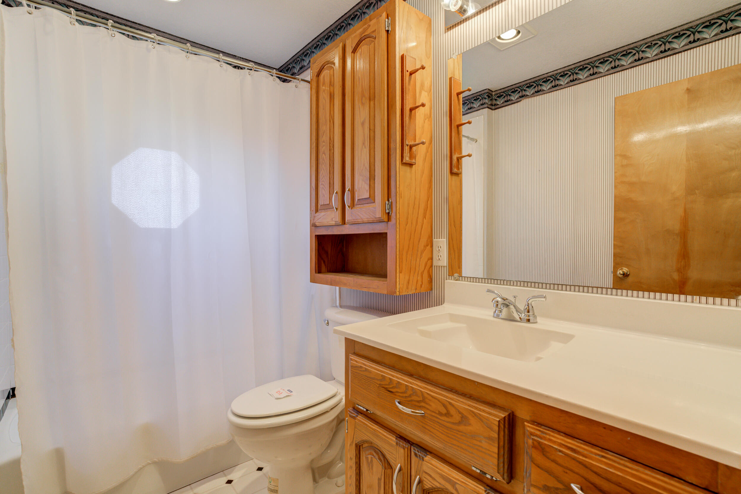 801 19th Street Seagraves, TX 79359 - Photo 20 of 24 a bathroom with a sink a toilet and shower