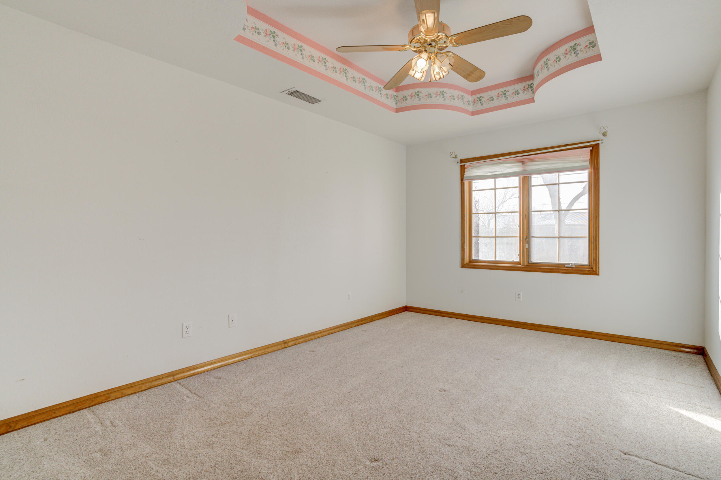 801 19th Street Seagraves, TX 79359 - Photo 21 of 24 an empty room with windows and fan