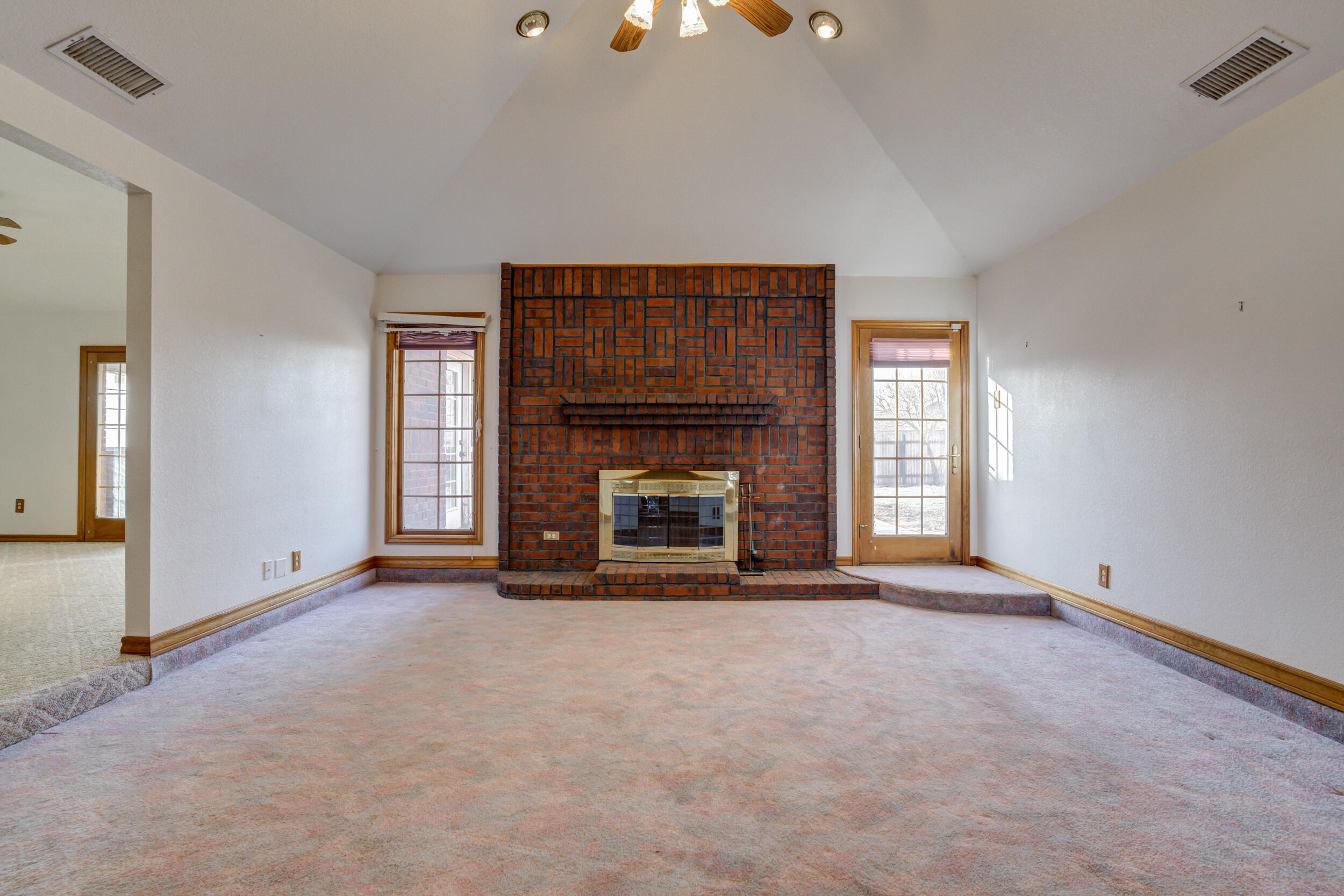 801 19th Street Seagraves, TX 79359 - Photo 7 of 24 an empty room with fireplace and window
