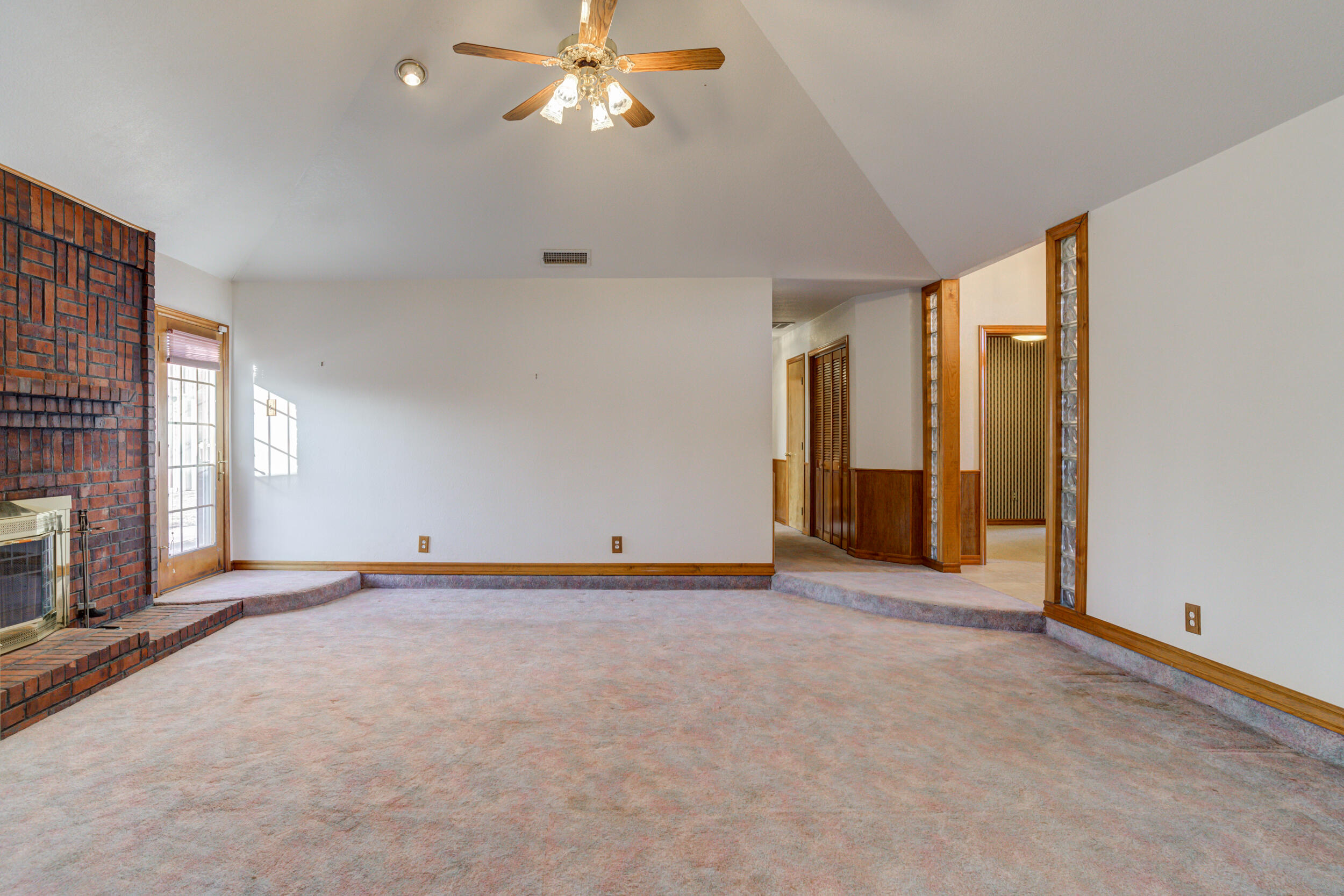 801 19th Street Seagraves, TX 79359 - Photo 9 of 24 a view of an empty room with a fireplace