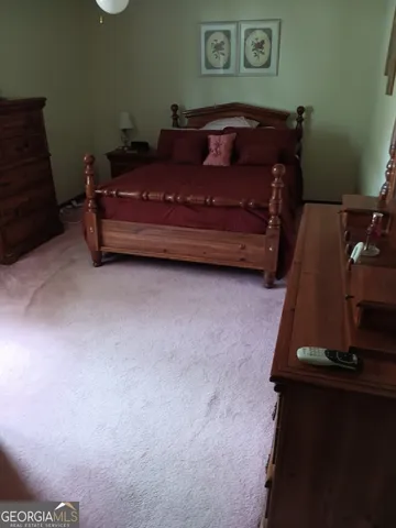 a bed sitting in a room next to a window