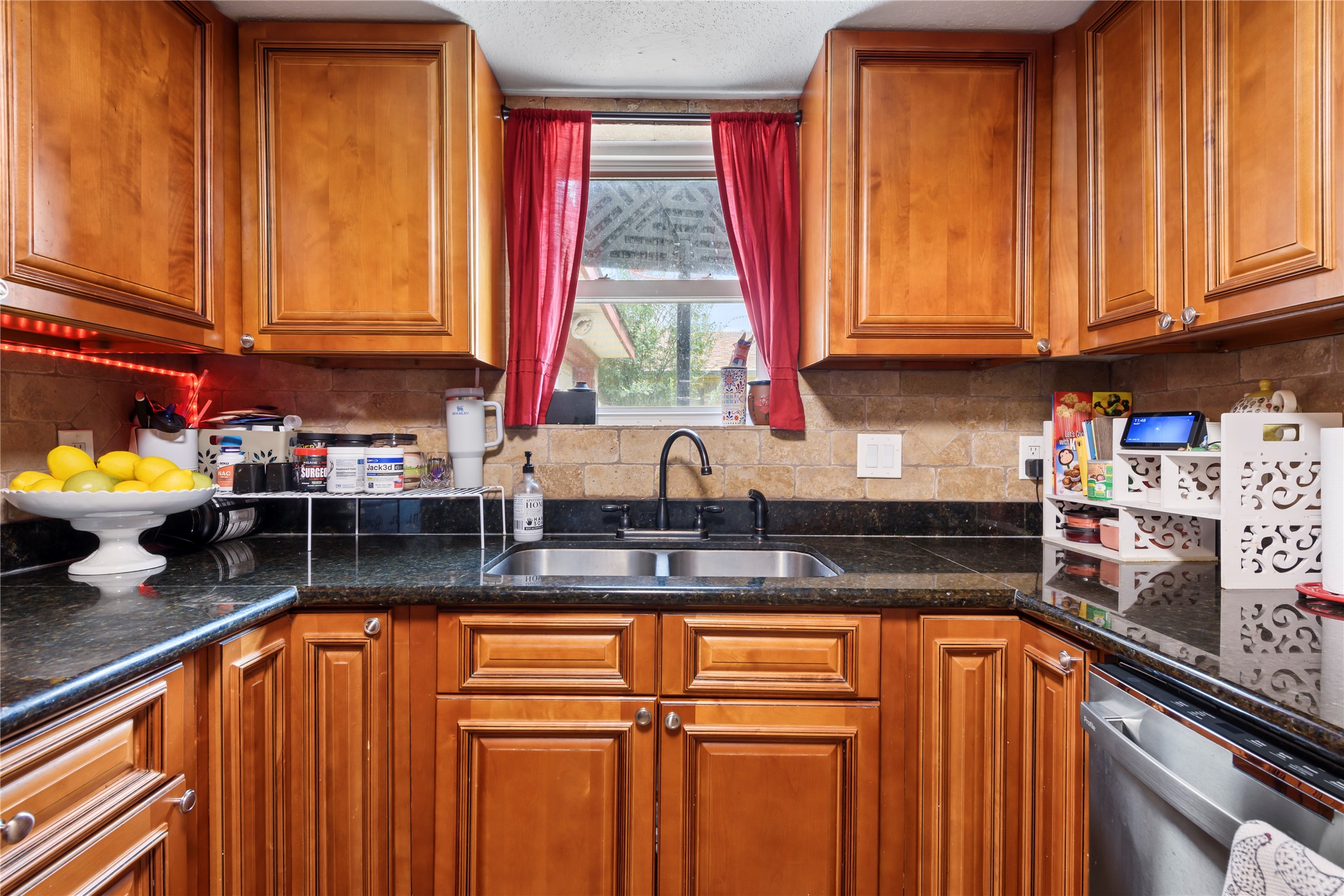 242 St Finans Way Houston, TX 77015 - Photo 11 of 25 a kitchen with stainless steel appliances granite countertop a sink a refrigerator and cabinets