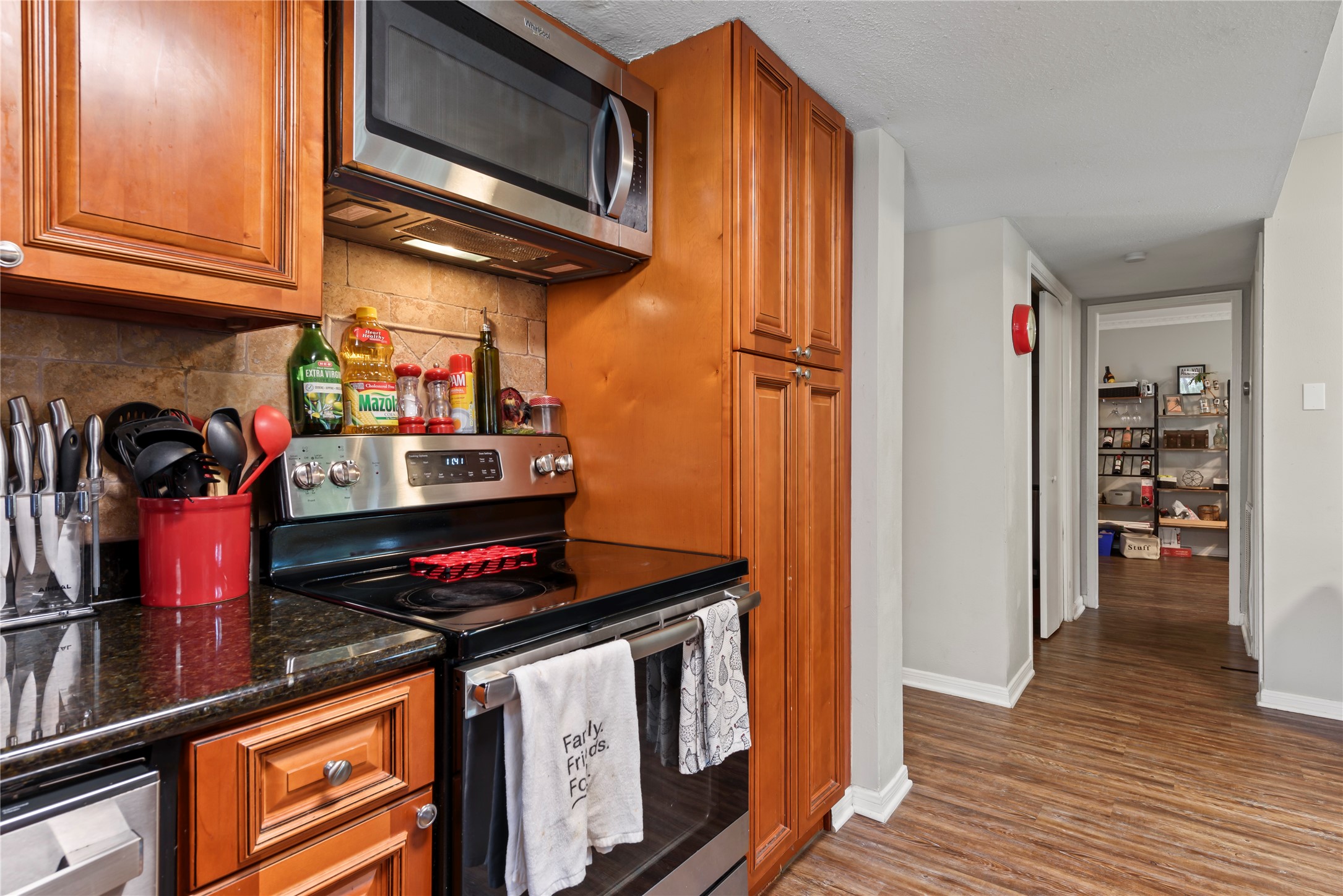 242 St Finans Way Houston, TX 77015 - Photo 12 of 25 a kitchen with stainless steel appliances granite countertop a stove and cabinets